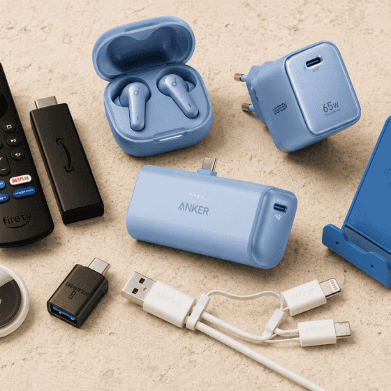 travel tech essentials including Fire TV Stick, portable charger, travel adapter and earbuds