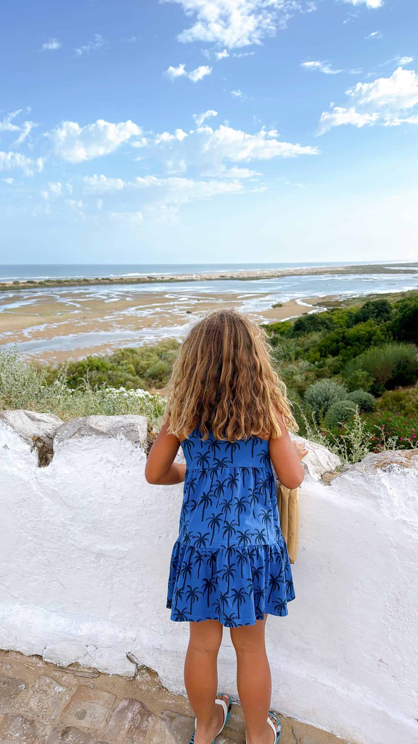 girl overlooking ria formosa at cacela velha