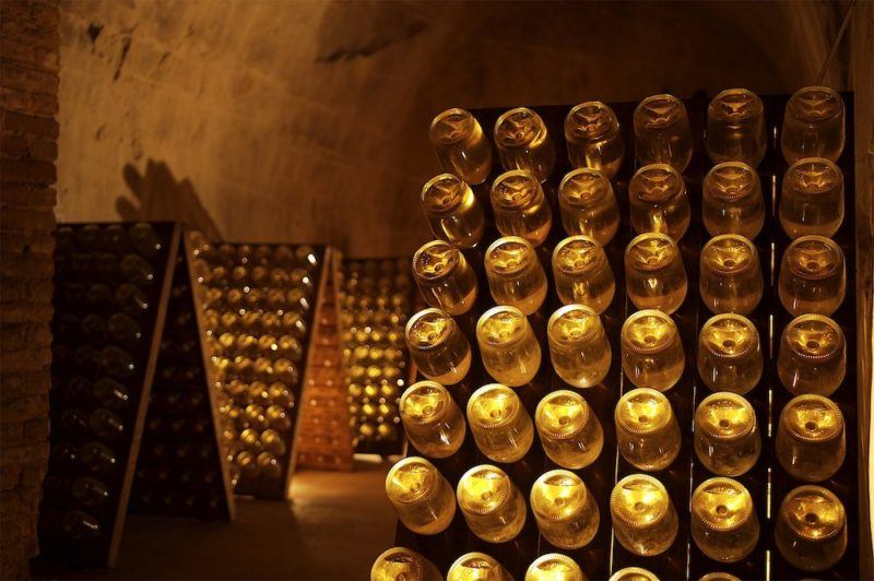 Bottles of champagne mature slowly and gracefully in the cool chalk cellars deep underground